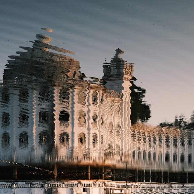 A reflection of a building in the water